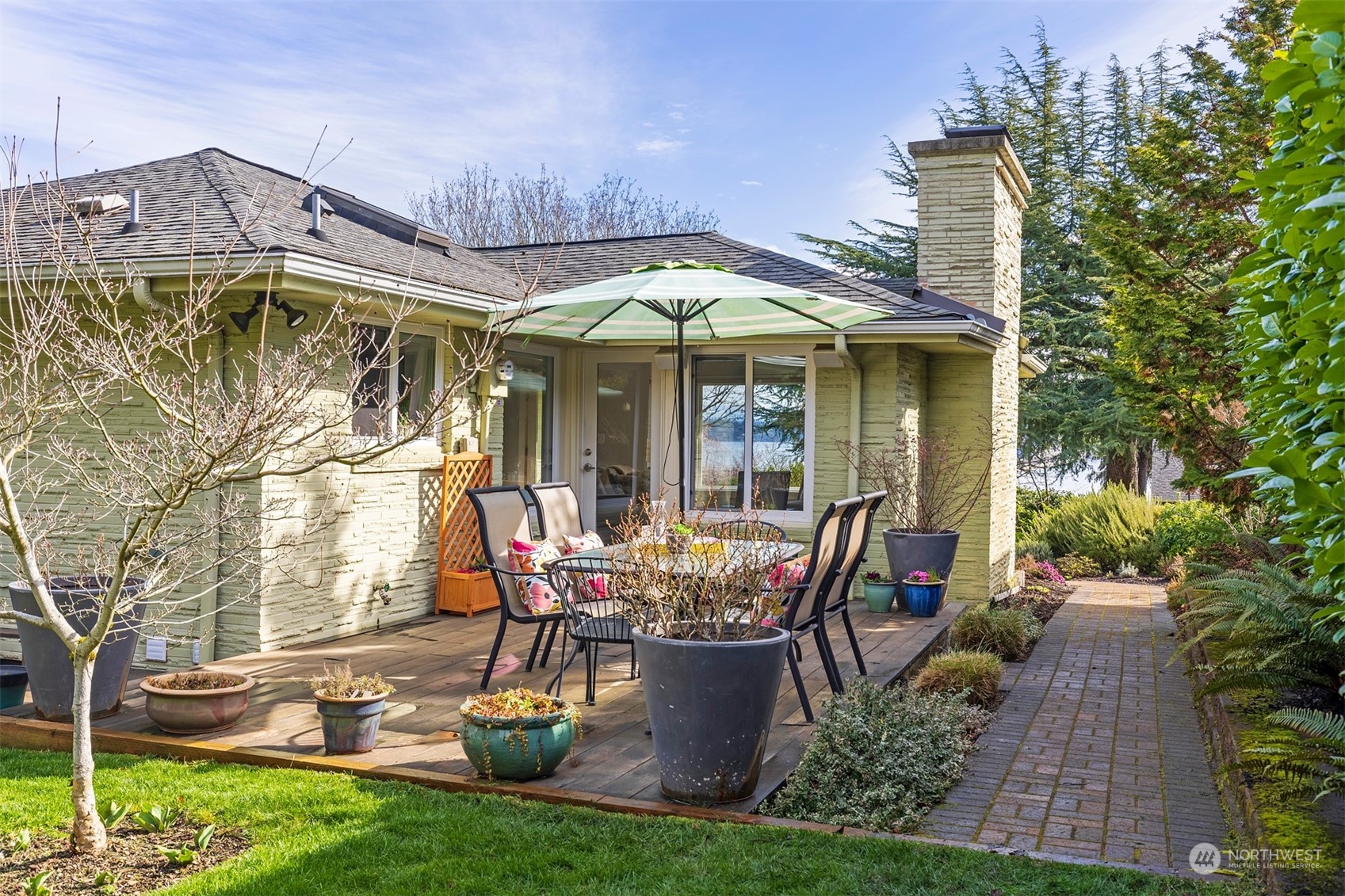 1505 35th Avenue South Seattle, WA 98144 - Photo 8 of 39 a view of a patio with table and chairs potted plants with wooden fence