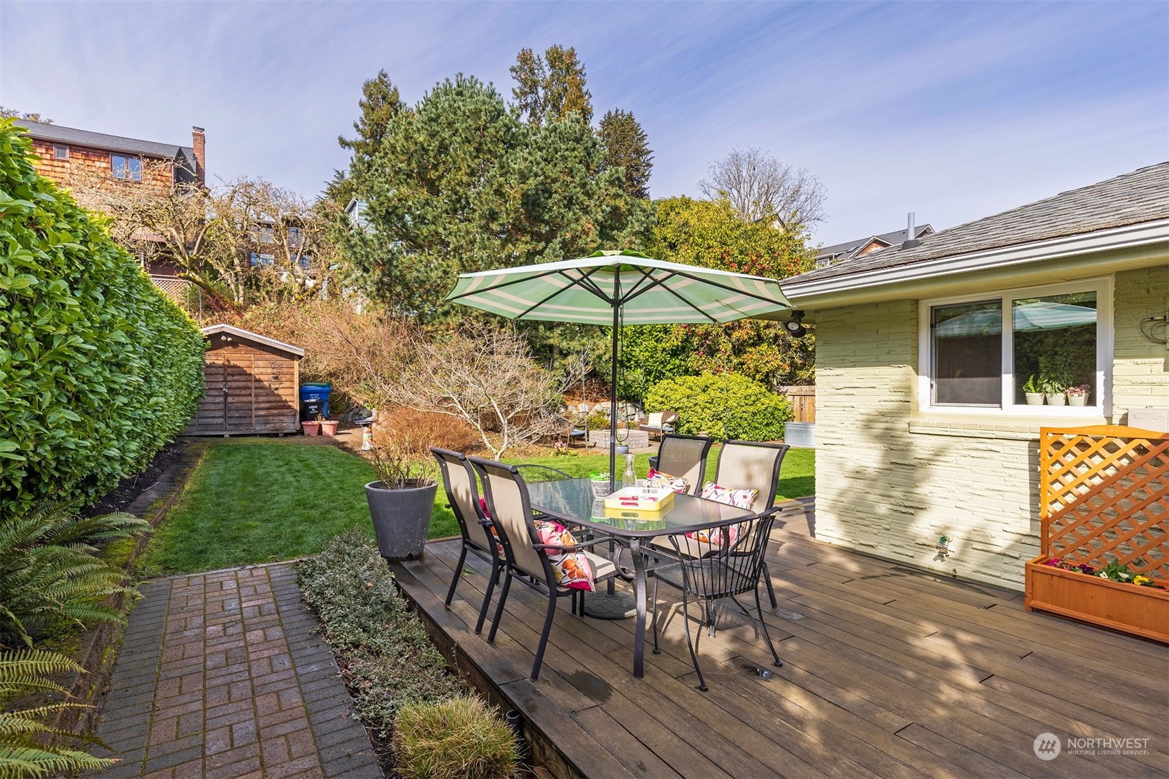 1505 35th Avenue South Seattle, WA 98144 - Photo 9 of 39 a view of a patio with table and chairs under an umbrella with a barbeque
