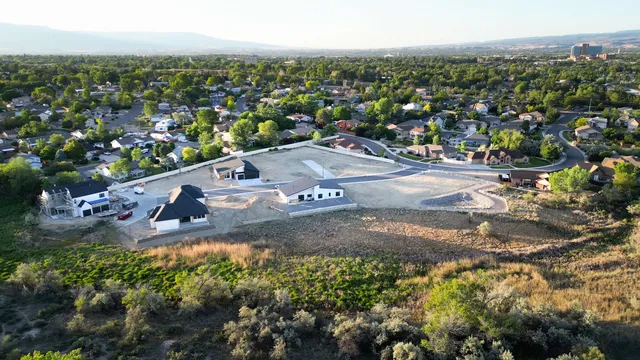 an aerial view of residential houses with outdoor space