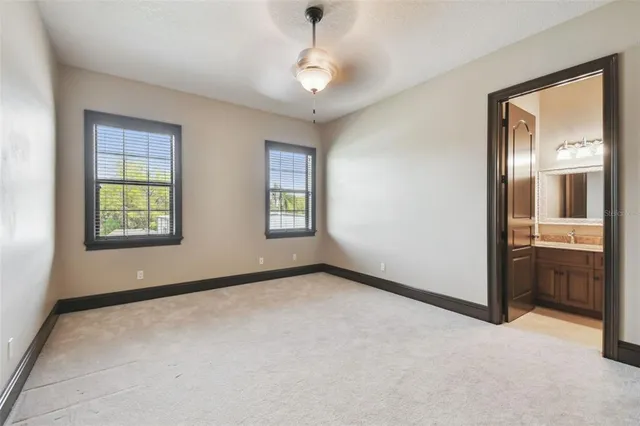 a bathroom with a granite countertop sink mirror vanity and toilet