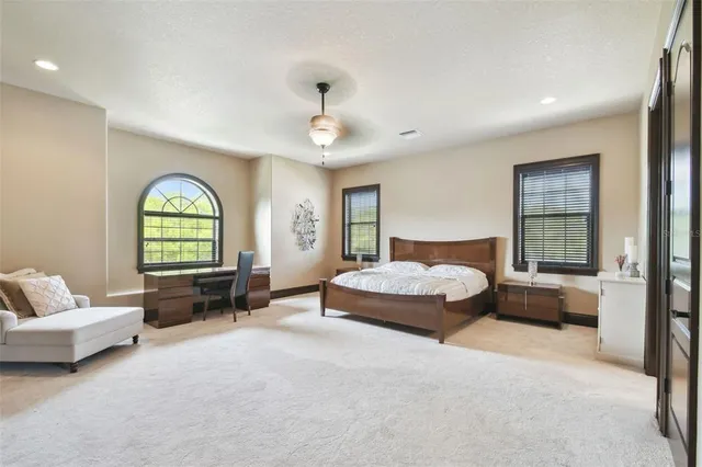 a bathroom with a granite countertop sink mirror vanity and toilet