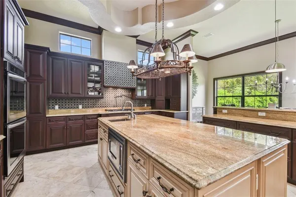 a kitchen with stainless steel appliances granite countertop a sink and a stove