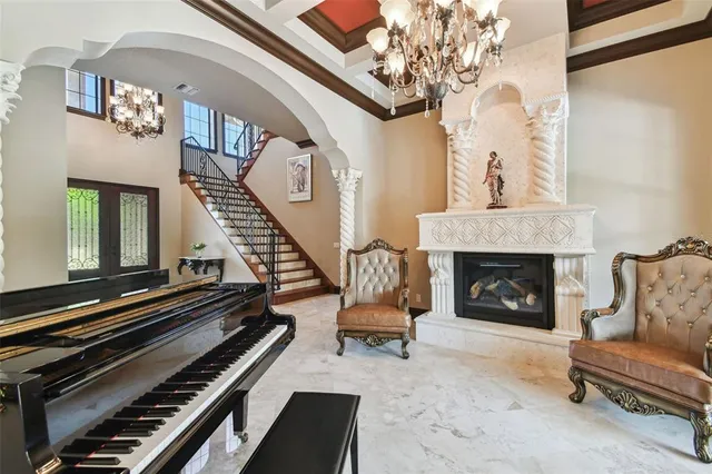 a bedroom with a bed window and a chandelier