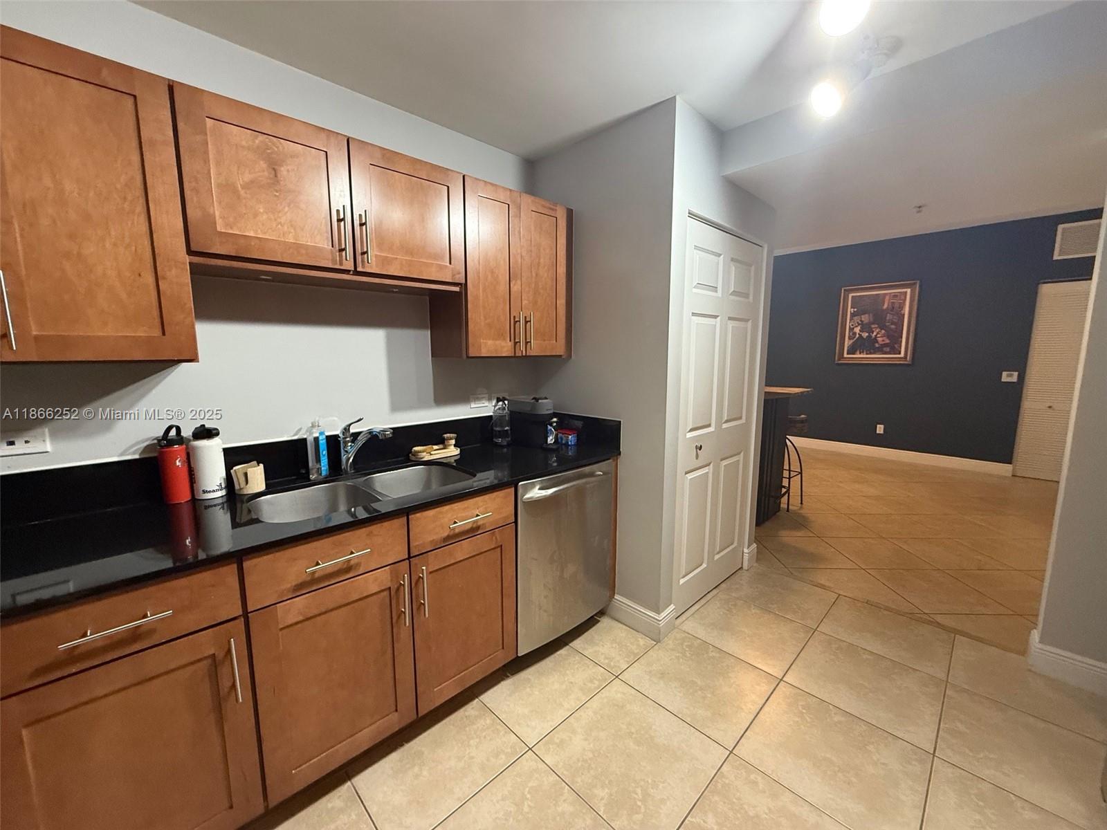 8395 Southwest 73rd Avenue, Unit 509 Miami, FL 33143 - Photo 11 of 41 a kitchen with stainless steel appliances granite countertop a refrigerator and cabinets
