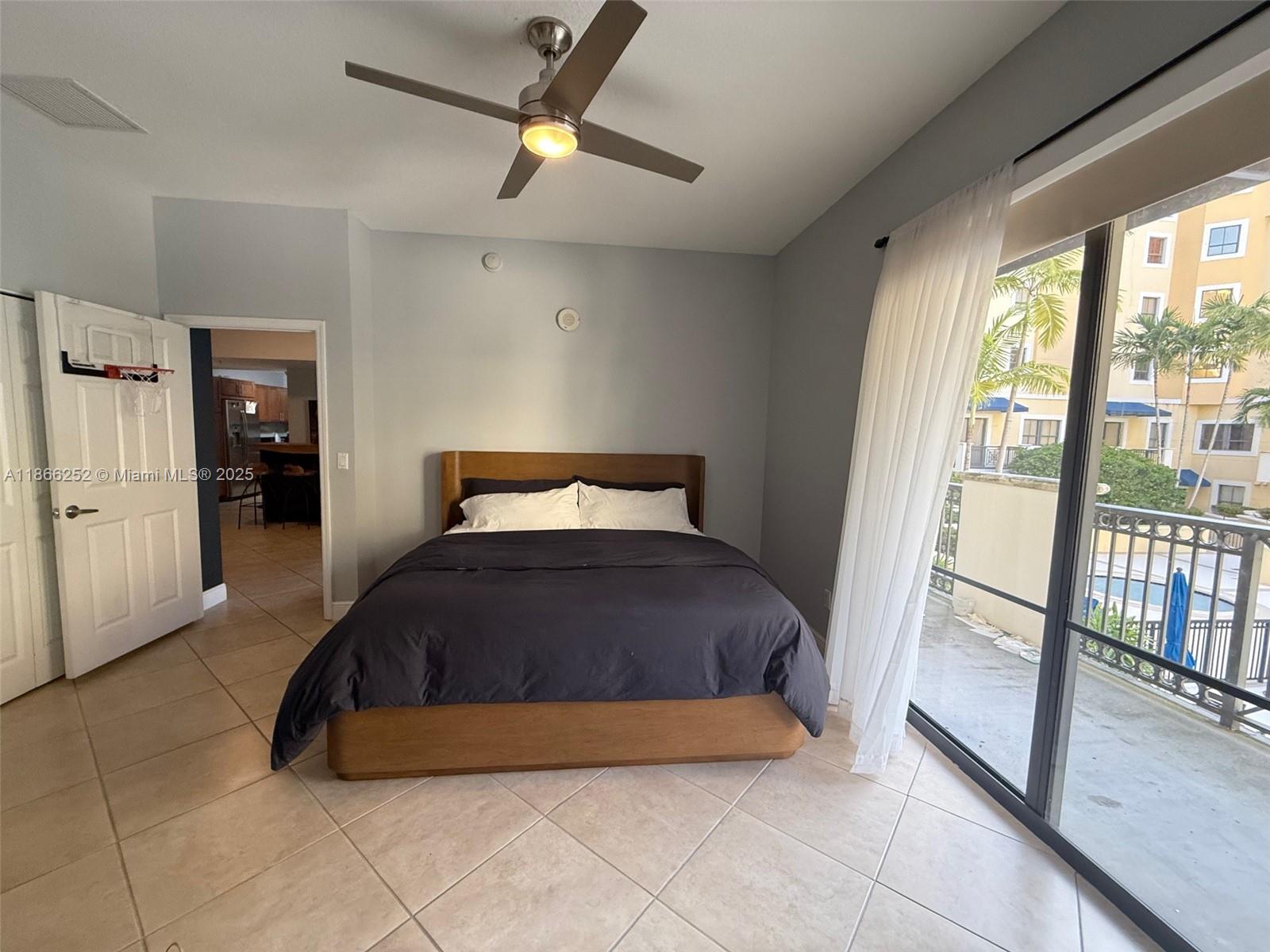 8395 Southwest 73rd Avenue, Unit 509 Miami, FL 33143 - Photo 14 of 41 a bedroom with a bed and a large window