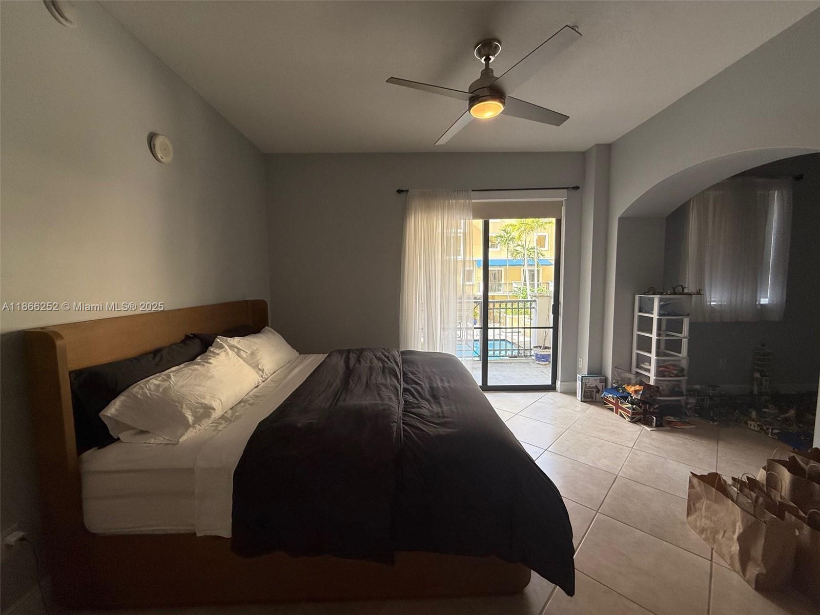 8395 Southwest 73rd Avenue, Unit 509 Miami, FL 33143 - Photo 15 of 41 a bedroom with a bed and a large window