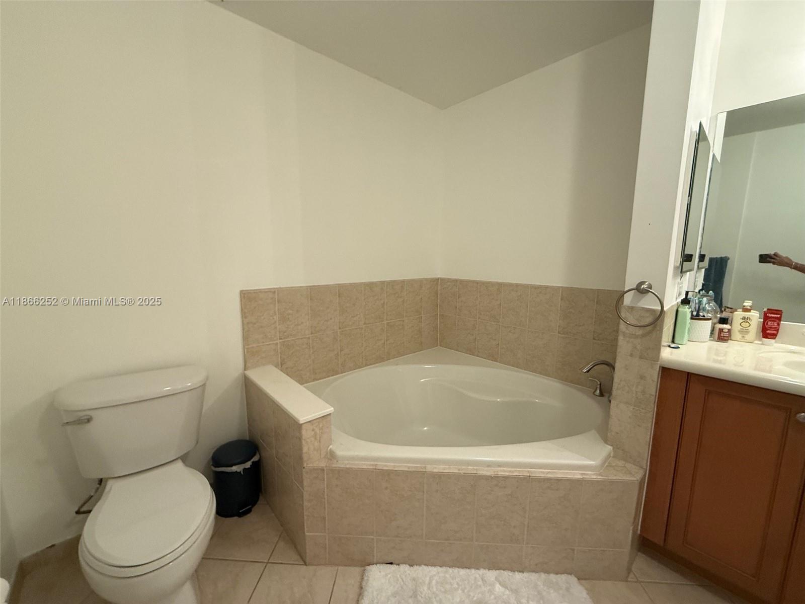 8395 Southwest 73rd Avenue, Unit 509 Miami, FL 33143 - Photo 19 of 41 a white bath tub sitting next to a white toilet