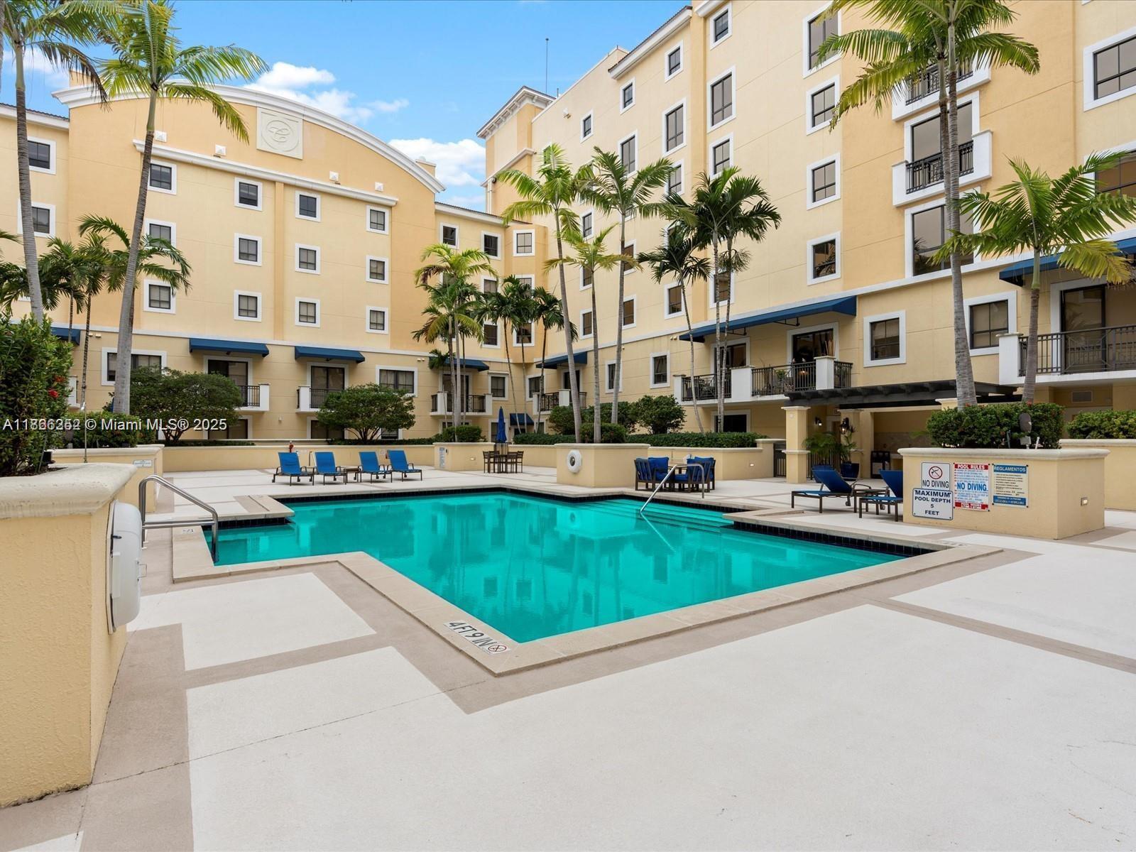 8395 Southwest 73rd Avenue, Unit 509 Miami, FL 33143 - Photo 33 of 41 a view of a street with a building and cars park in front of it