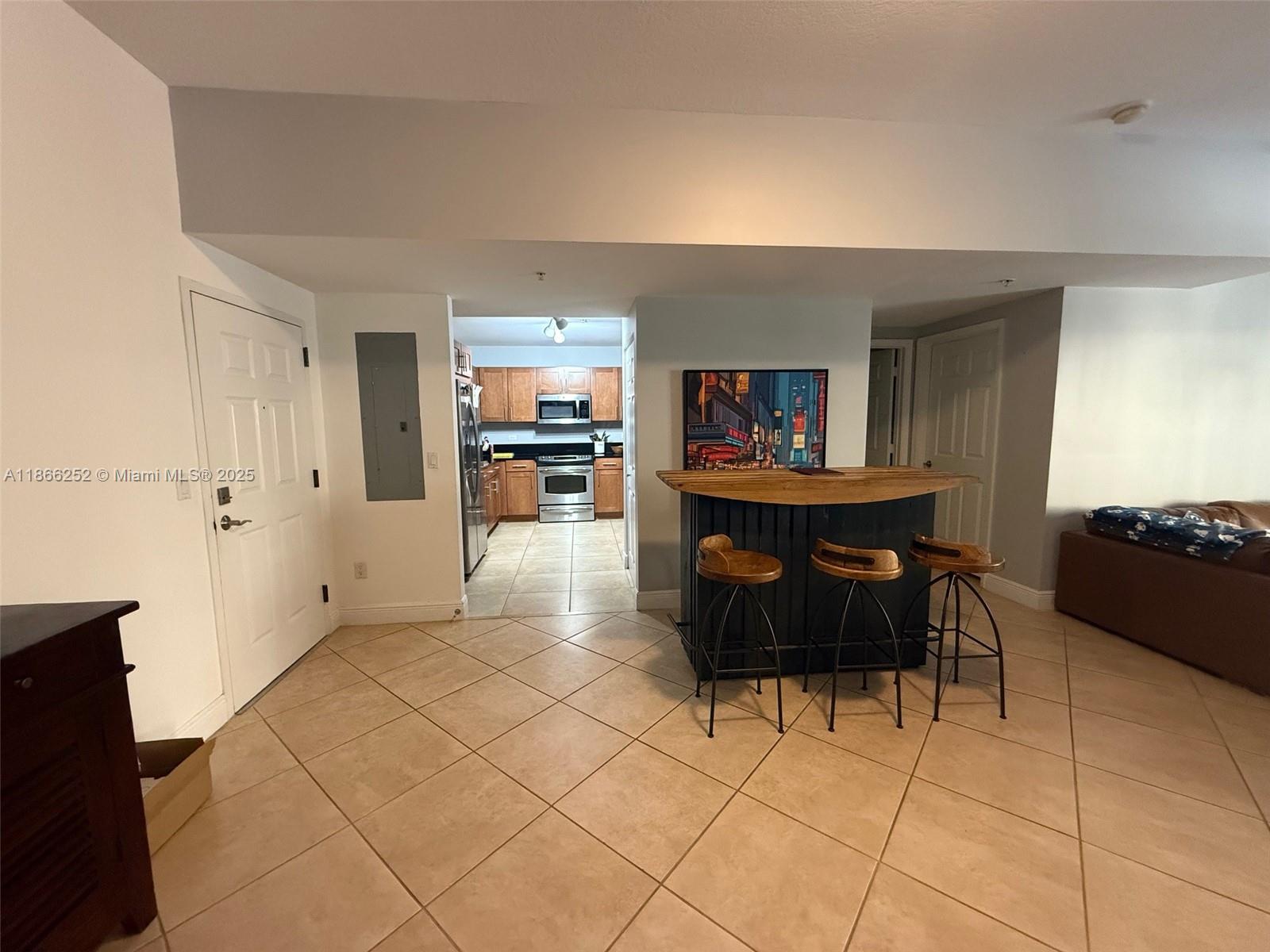 8395 Southwest 73rd Avenue, Unit 509 Miami, FL 33143 - Photo 6 of 41 a living room with furniture and a kitchen view