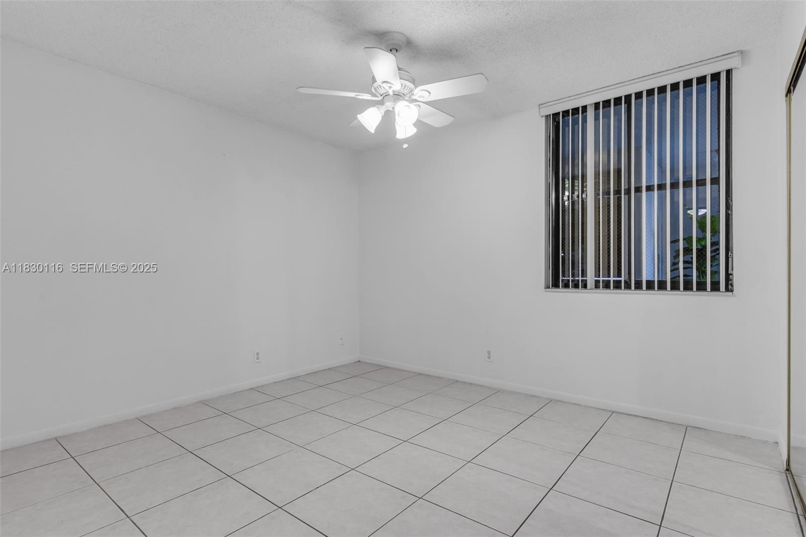 12239 Southwest 14th Lane, Unit 3212 Miami, FL 33184 - Photo 19 of 36 a view of an empty room with a window