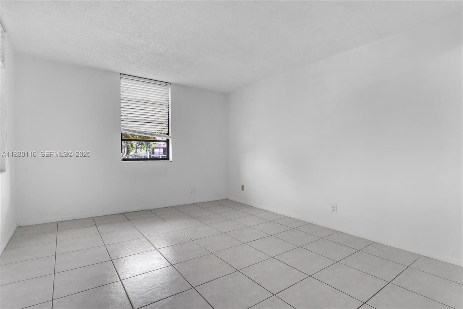 12239 Southwest 14th Lane, Unit 3212 Miami, FL 33184 - Photo 21 of 36 an empty room with windows