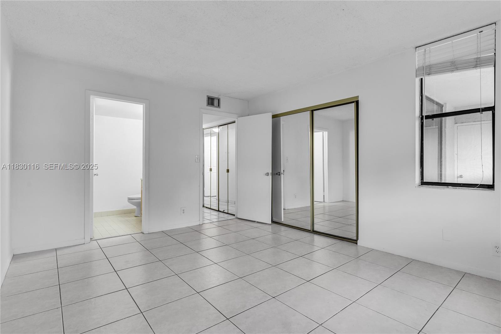 12239 Southwest 14th Lane, Unit 3212 Miami, FL 33184 - Photo 22 of 36 a view of a refrigerator in kitchen and empty room
