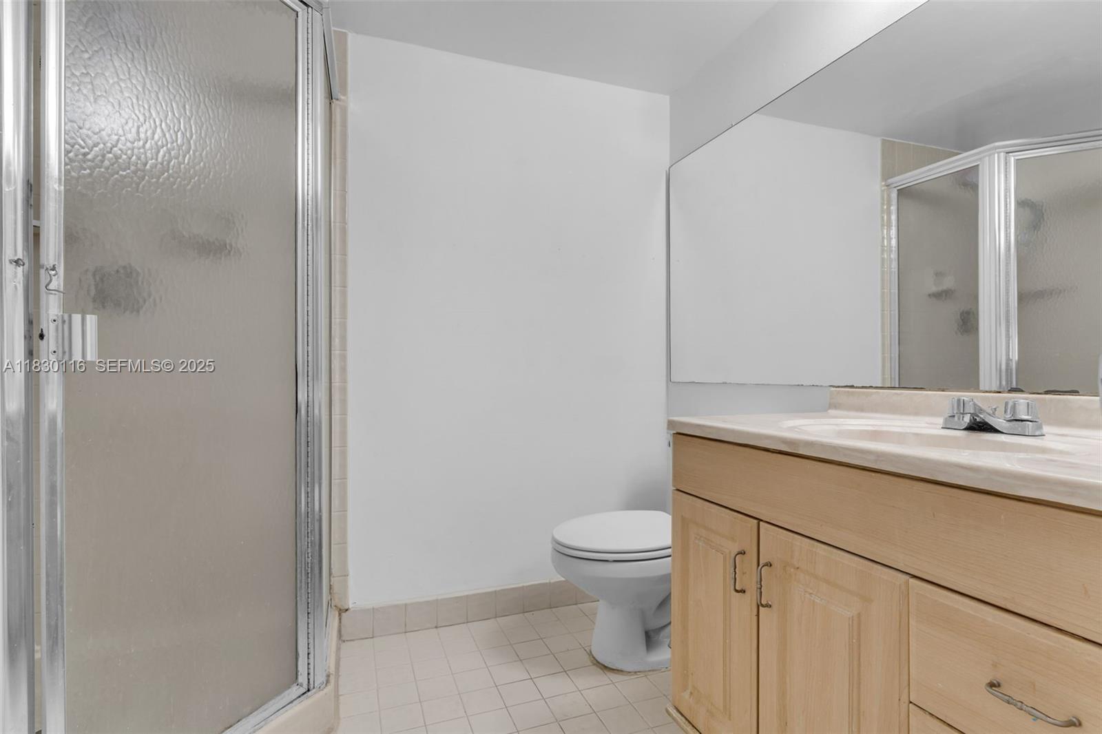 12239 Southwest 14th Lane, Unit 3212 Miami, FL 33184 - Photo 23 of 36 a bathroom with a granite countertop sink toilet and shower