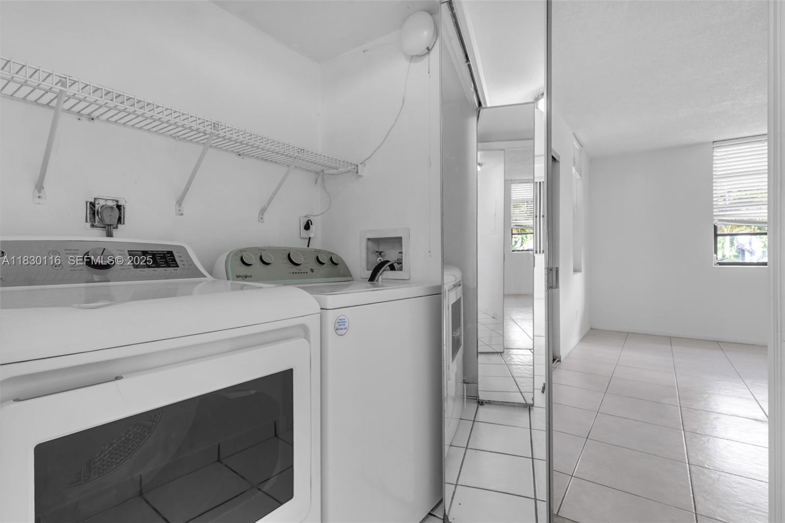 12239 Southwest 14th Lane, Unit 3212 Miami, FL 33184 - Photo 25 of 36 a utility room with cabinets washer and dryer