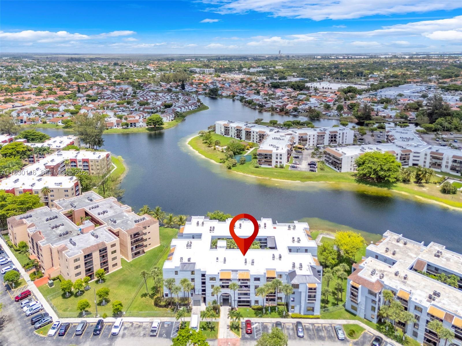 12239 Southwest 14th Lane, Unit 3212 Miami, FL 33184 - Photo 27 of 36 an aerial view of a city with lots of residential buildings ocean and mountain view in back