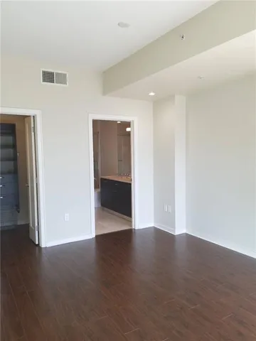 a view of wooden floor and windows in a room