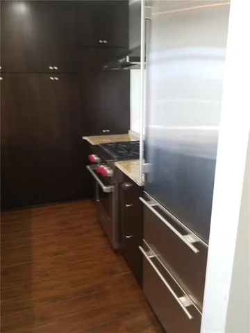 a kitchen with granite countertop a refrigerator and a stove