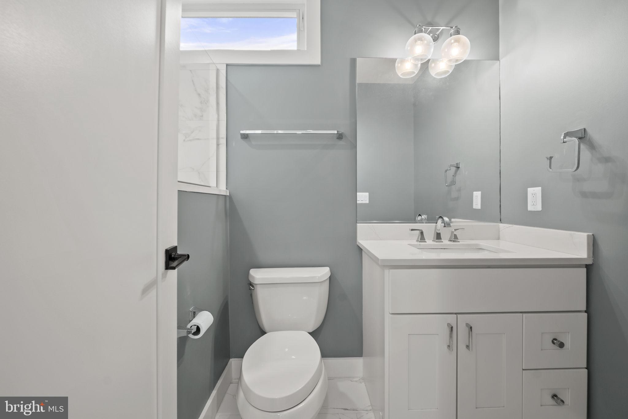 4315 Harrison Street Northwest, Unit 5 Washington, DC 20015 - Photo 16 of 33 a bathroom with a toilet a sink and mirror