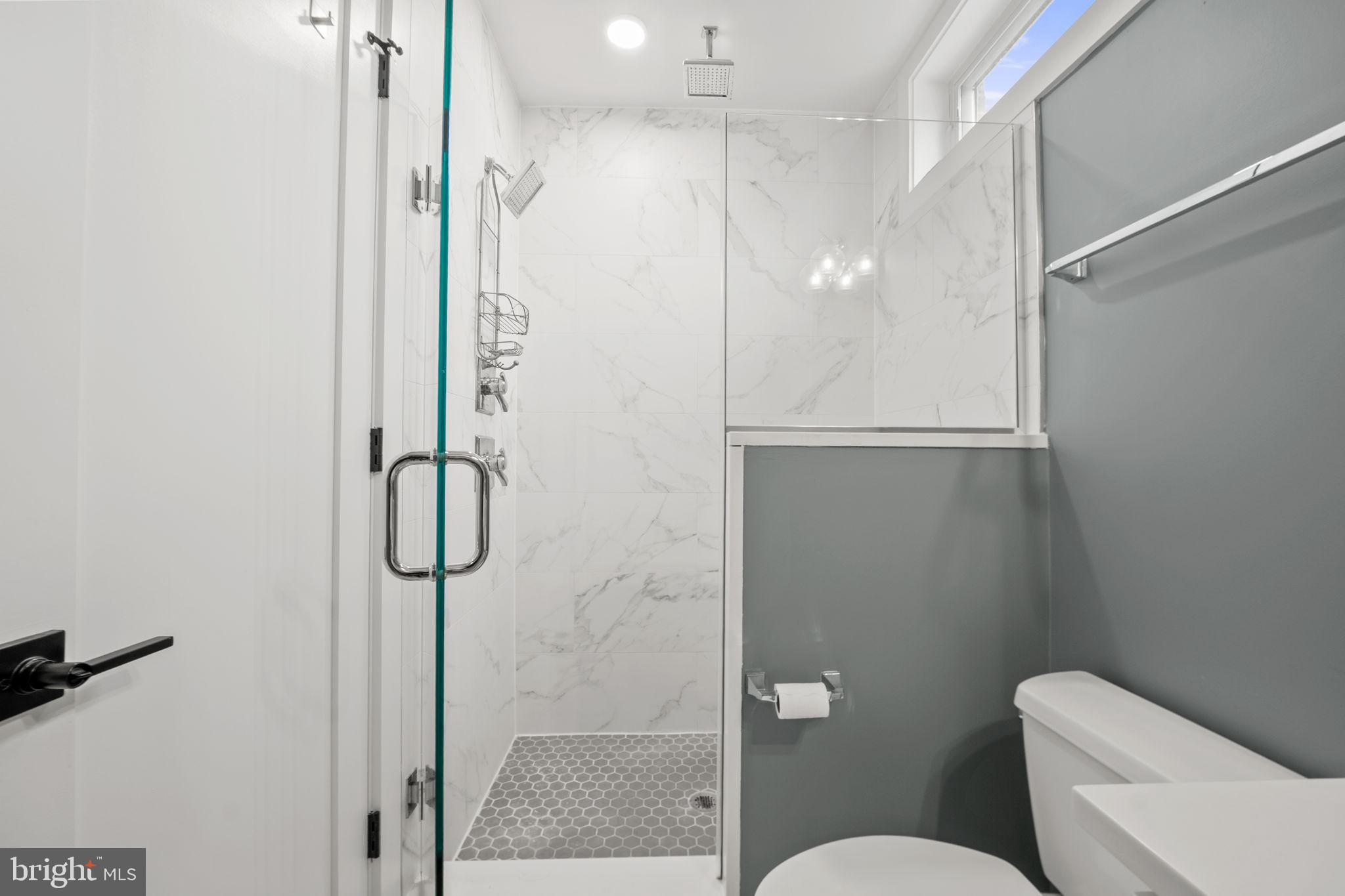 4315 Harrison Street Northwest, Unit 5 Washington, DC 20015 - Photo 17 of 33 a bathroom with a shower and toilet