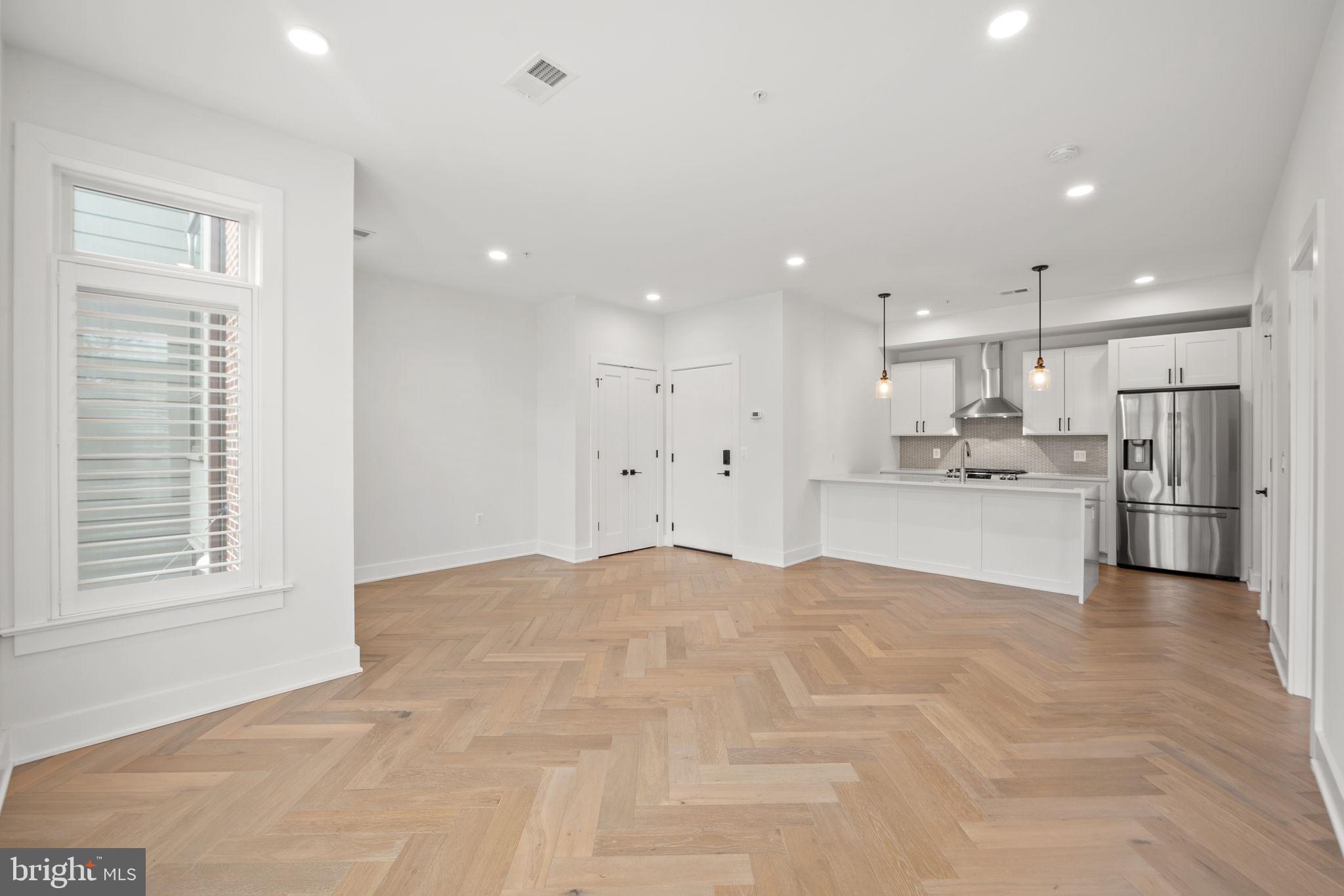 4315 Harrison Street Northwest, Unit 5 Washington, DC 20015 - Photo 10 of 33 a view of kitchen with kitchen island a sink stainless steel appliances and cabinets