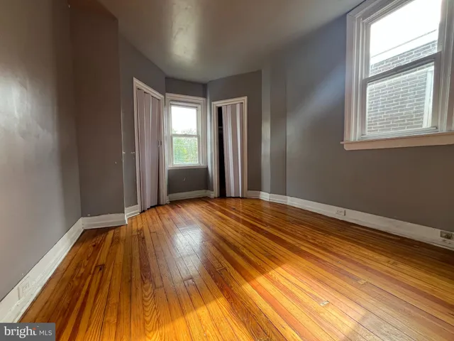 a view of a room with wooden floor and window