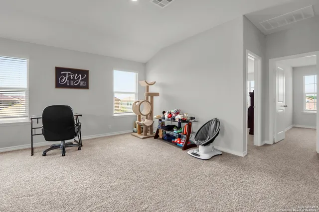 a work room with furniture and a flat screen tv
