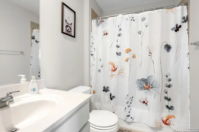 a bathroom with a sink toilet and a mirror