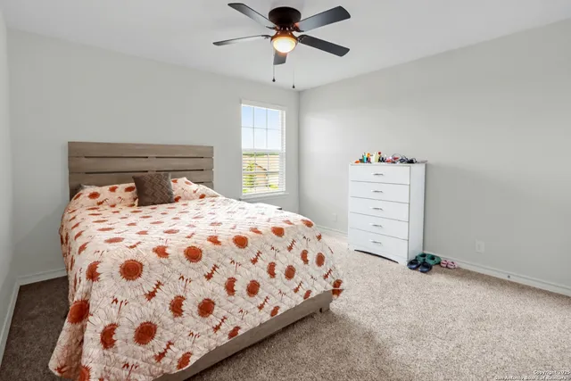 a bathroom with a sink a toilet and shower curtain