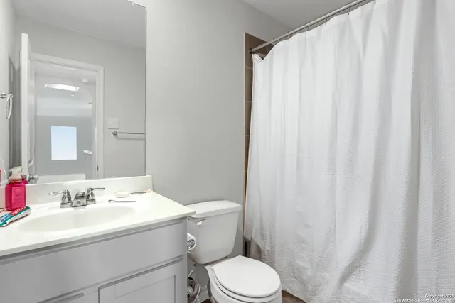 a living room with furniture a ceiling fan and a window
