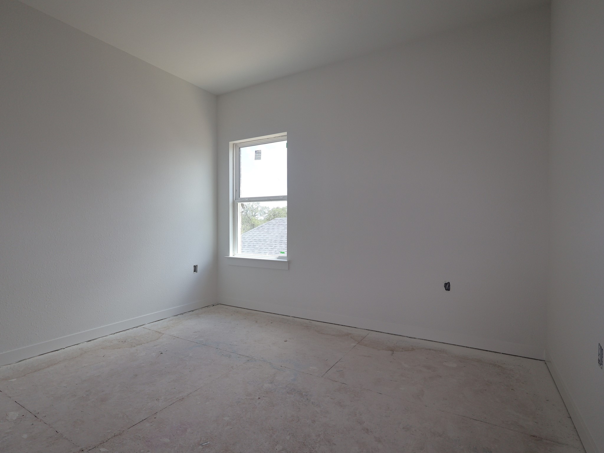 261 Callahan Loop Buda, TX 78610 - Photo 11 of 19 an empty room with a window