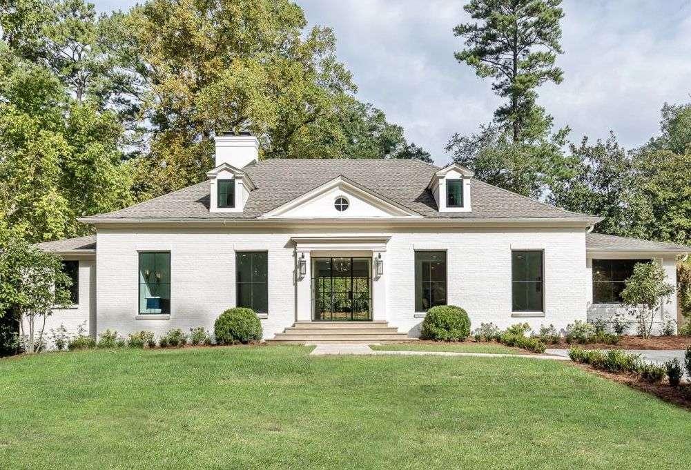a front view of a house with a garden