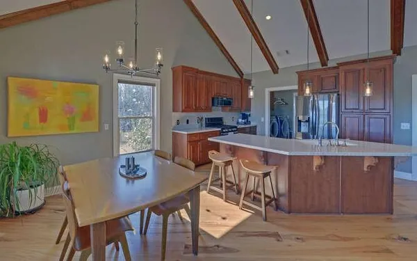 a view of a dining room with furniture and wooden floor