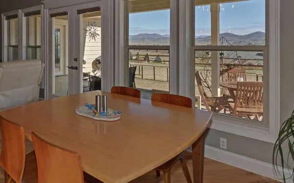 a view of a dining room with furniture window and wooden floor