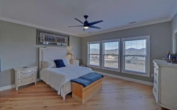a living room with a bed furniture and a large window