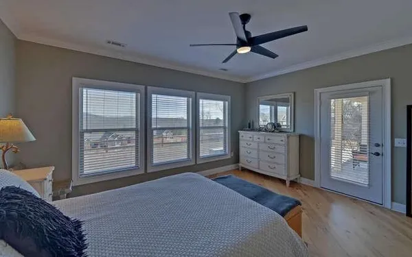 a bedroom with a large bed and a large window