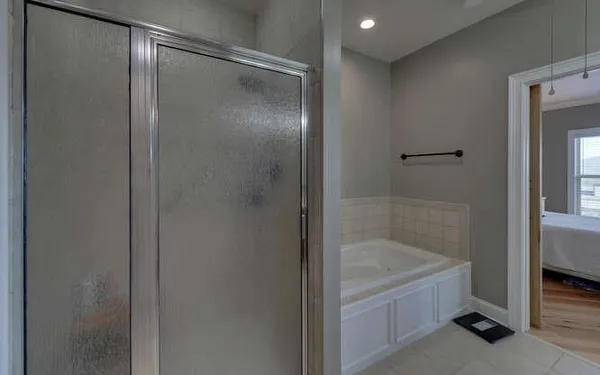 a bathroom with a bathtub and shower