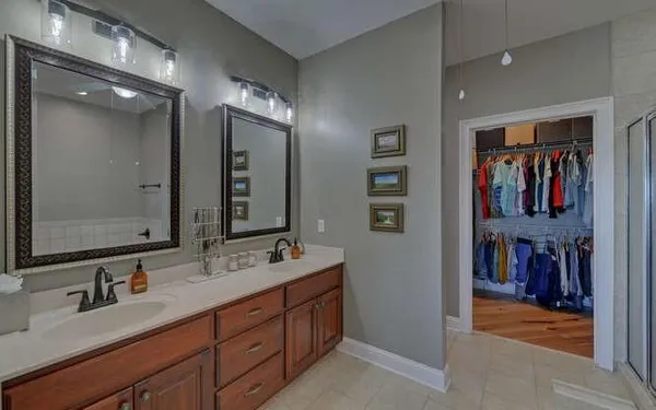 a bathroom with a sink double vanity and a mirror