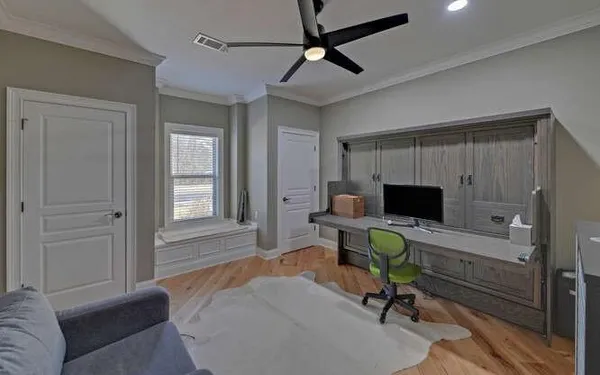 a view of a livingroom with workspace and a window