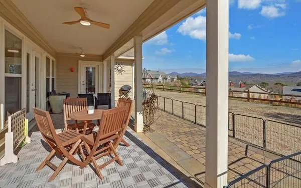 a dining room with furniture water view and a floor to ceiling window