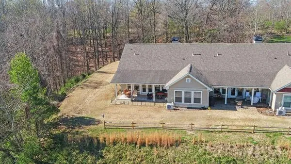 a view of house with outdoor space and seating area