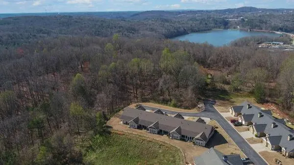 an aerial view of a house with a yard