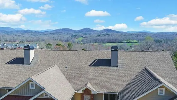 a view of a house with a yard and mountain