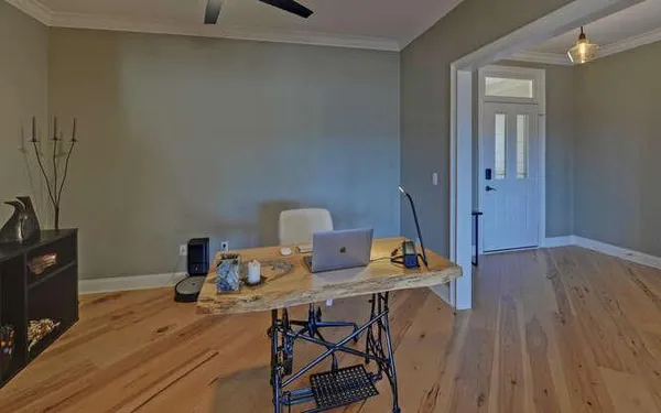 a view of a workspace with furniture and wooden floor