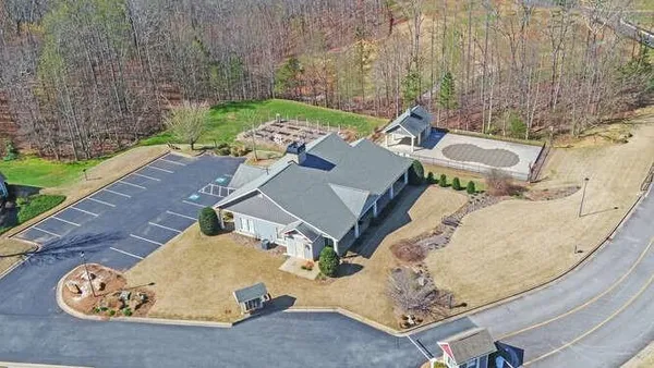 an aerial view of a house with a yard