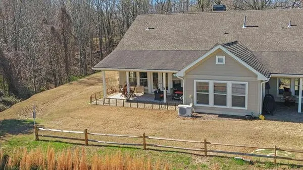 aerial view of a house with swimming pool and sitting area