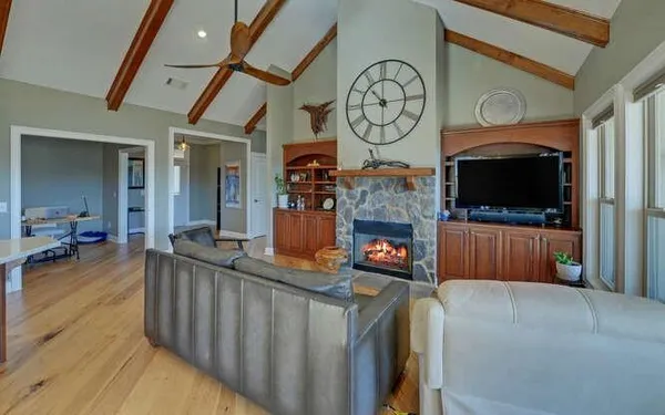a living room with furniture a flat screen tv and a fireplace