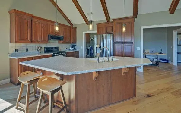 a kitchen with a table chairs sink and cabinets