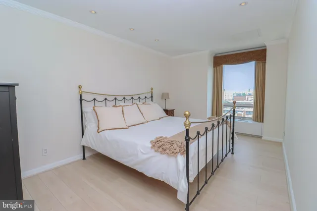 a bed room with a bed and a large window