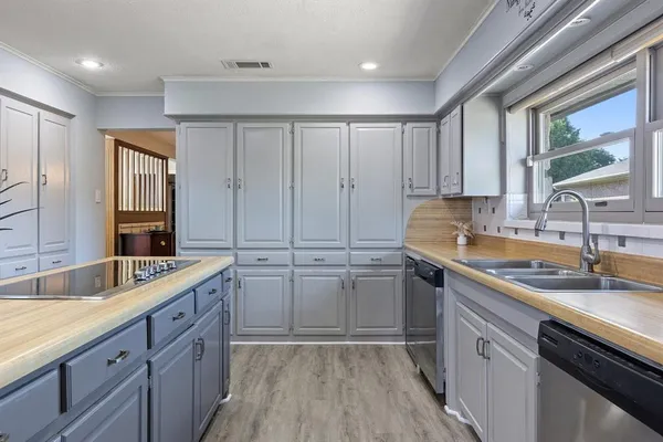 a kitchen with a sink and cabinets