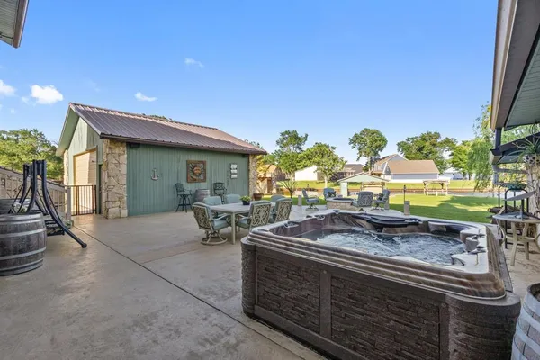 a view of a patio with a table chairs and a backyard